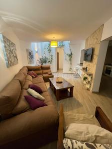 a living room with a brown couch and a table at La morena in Guaro