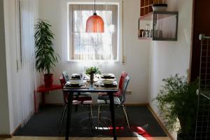 a table and chairs in a room with a window at Biburg86420 in Biburg