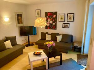 a living room with two couches and a tv at Biburg86420 in Biburg