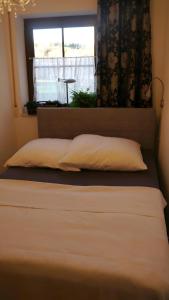 a bed in a room with a window and a pillow at Biburg86420 in Biburg