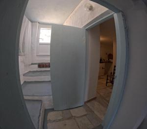 a hallway with a mirror in a room at Seagull Syros Seaside in Ermoupoli