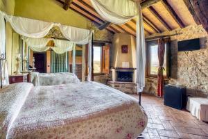 a bedroom with a large bed and a fireplace at Le Buccole Country House in Marsciano