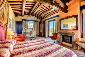 a bedroom with a large bed and a fireplace at Le Buccole Country House in Marsciano +36 photos