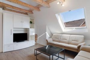 a living room with a couch and a tv at Caroline Magg in Lindau