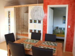 a dining room with a table and chairs at Ferienwohnungen Pano in Friedrichshafen