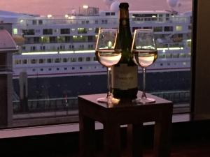a bottle of wine and two glasses on a table at Excelsior Apartments - Liverpool Central - Free Parking - AirCon in Liverpool