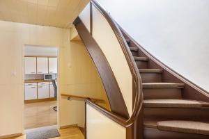 a spiral staircase in a house with a kitchen at Ferienwohnung Hennen in Witzenhausen +15 photos