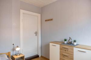 a bedroom with a dresser with a cross on the wall at Ferienwohnung Hennen in Witzenhausen
