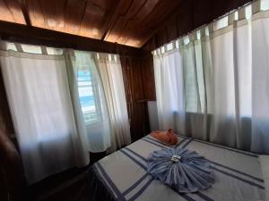 a bedroom with a bed with a blue umbrella on it at Hotel Lucy in Montezuma