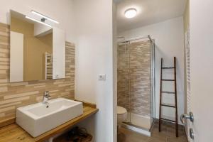 a bathroom with a sink and a glass shower at Appartamento Pila Vacanze in Gressan +35 photos
