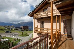 a balcony of a house with a view of the mountains at Appartamento Pila Vacanze in Gressan