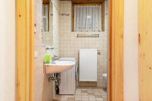 a bathroom with a sink and a toilet at Thomasegg Hof Birke in Sarntal +27 photos