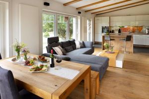 a living room with a couch and a table at Ferienhaus Chalet Bergblick in Stryck