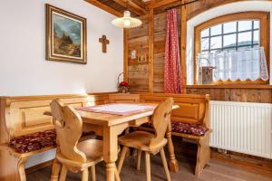 a dining room with a wooden table and chairs at Thomasegg Hof Birke in Sarntal
