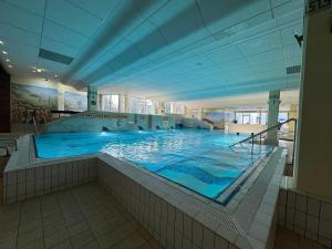 a large swimming pool in a large building at Bayerwaldresort in Sankt Englmar