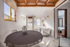 a dining room with a black table and chairs at Apartamento Amarelo T1 in Odeceixe