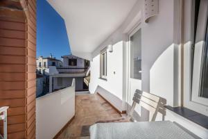 a balcony with a table and chairs on a building at Apartamento Amarelo T1 in Odeceixe