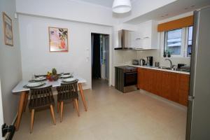 a kitchen with a table and two chairs and a sink at Casa Marjeta in Chania +19 photos