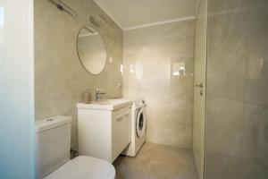 a bathroom with a toilet and a sink and a mirror at Casa Marjeta in Chania