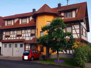 a red car parked in front of a house at Haus48 in Neuried