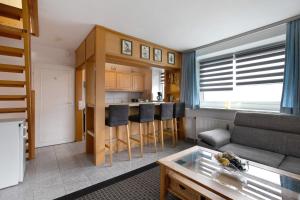 a living room with a couch and a kitchen at Sylt Ferienwohnung 4 Westerland in Westerland