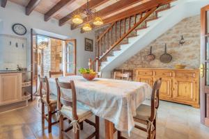 a kitchen and dining room with a table and chairs at S'era in Santanyi
