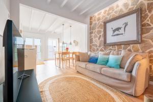 a living room with a couch and a table at Casa Sol y Luna in Artá