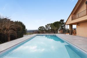 a swimming pool in the backyard of a house at Casanova de Noet in Aviá