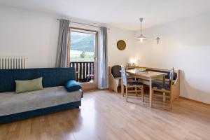 a living room with a couch and a table at Bauernhof Sackgut in Ciardes