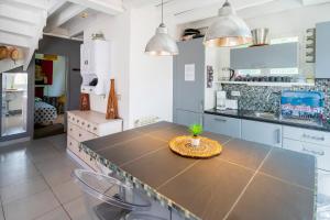 a kitchen with a table with a plant on it at Vacances Pays Basque in Bidart +14 photos