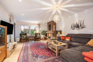 a living room with a couch and a table at Ferienhaus Timm in Meldorf