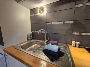 a kitchen with a sink with a towel on it at Le Chalet Cocon et Jacuzzi in La Petite-Pierre +30 photos