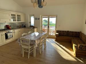 a kitchen with a table and chairs and a couch at Villa Edith in Parghelia
