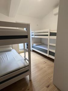a room with two bunk beds and a hallway at Villa Edith in Parghelia