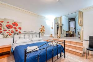 a bedroom with a blue bed and a balcony at Meraviglie Salentine - Lecce in Lequile