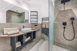 a bathroom with a sink and a shower at See das Ferienhaus in Oetz +31 photos