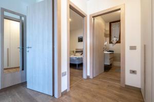 a hallway with a bathroom with a sink and a mirror at Agriturismo Bocca Nevese Abete in Tremosine Sul Garda +24 photos