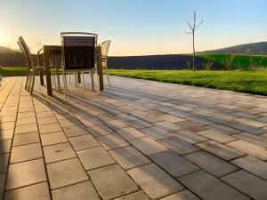 a table and chairs sitting on a patio at Ferienwohnungen Joachim Fischer in Gündelbach