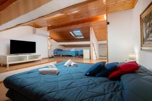 a large blue bed in a room with a tv at Affittacamere Monica in Levanto