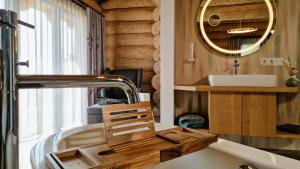 a bathroom with a sink and a mirror at Naturstamm Chalets in Untergriesbach +42 photos
