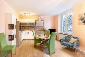 a kitchen and dining room with a table and chairs at Serviced Apartments Xanthurus in Schwelm