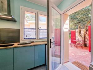 a kitchen with a sink and a sliding glass door at Villa Galatea Exclusive in Capoliveri +37 photos