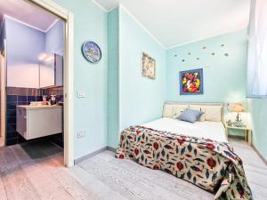 a bedroom with a bed and a blue wall at Villa Galatea Exclusive in Capoliveri