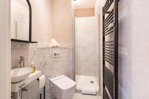 a bathroom with a toilet and a sink at Serviced Apartments Xanthurus in Schwelm +39 photos