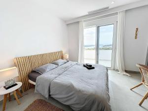 a bedroom with a bed and a large window at The Privacy Villa by Seaviews in Porto Heli +37 photos