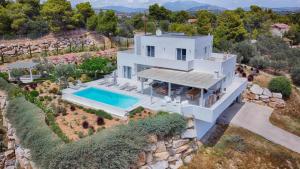 an aerial view of a white house with a swimming pool at The Privacy Villa by Seaviews in Porto Heli
