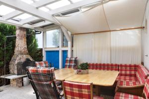 a patio with a wooden table and chairs at Ferienwohnung Eichenauer in Angersbach