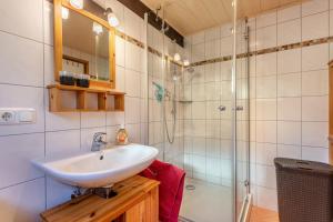 a bathroom with a sink and a shower at Ferienhaus Vorauf - Rosenbauer in Siegsdorf