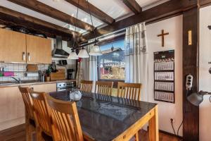 a kitchen with a dining room table and chairs at Ferienhaus Vorauf - Rosenbauer in Siegsdorf +10 photos