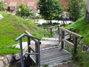 a set of stairs with a wooden bench in a yard at Fewo Furtwangen in Furtwangen +30 photos
